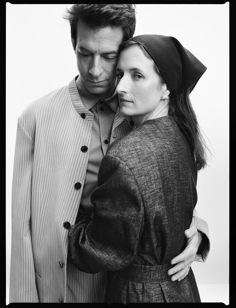 Monochrome portrait of a man and a woman embracing against a white background for Calvin Klein Collection Fall 2026.