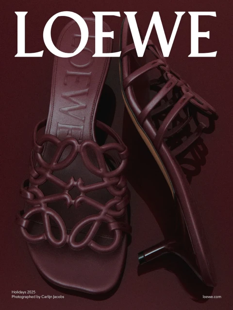 Loewe Holiday 2025 campaign featuring a pair of high-heeled sandals in burgundy, displayed on a matching burgundy backdrop.