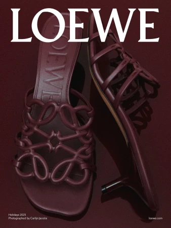 Loewe Holiday 2025 campaign featuring a pair of high-heeled sandals in burgundy, displayed on a matching burgundy backdrop.