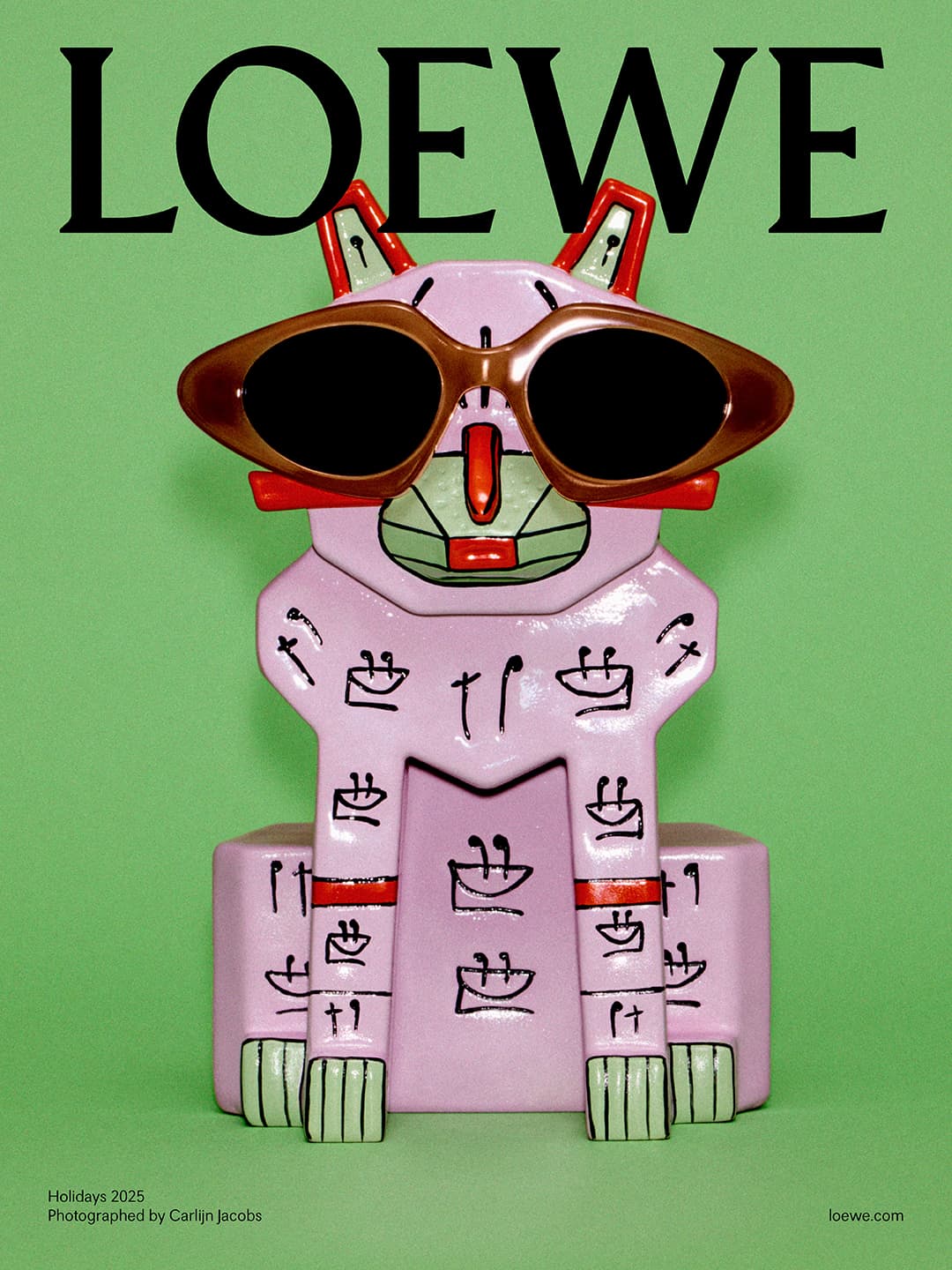 Loewe Holidays 2025 campaign featuring a pink sculpture of a cat wearing sunglasses on a light green background, with Loewe logo.