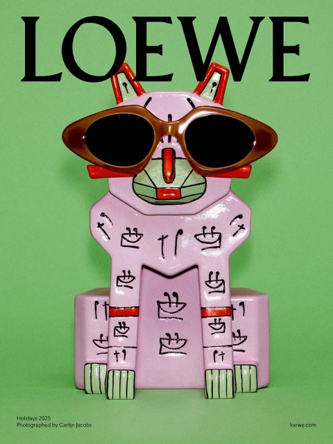 Loewe Holidays 2025 campaign featuring a pink sculpture of a cat wearing sunglasses on a light green background, with Loewe logo.