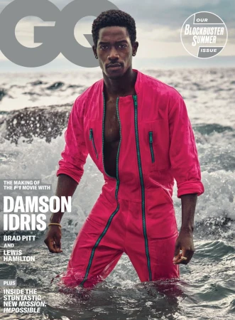 Magazine cover featuring Damson Idris in a pink jumpsuit, standing in ocean waves. GQ logo and summer blockbuster issue text visible.