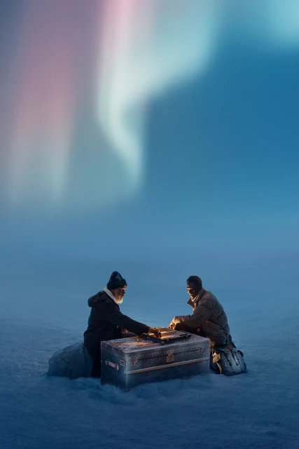 Two men sit near a chest outdoors, under a mesmerizing display of the Aurora Borealis, illuminated by warm light sources.