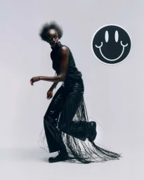Model Nyaueth Riam wearing black fringe pants and sleeveless top with smiley graphic for HardCOPY Magazine NYAUETH editorial