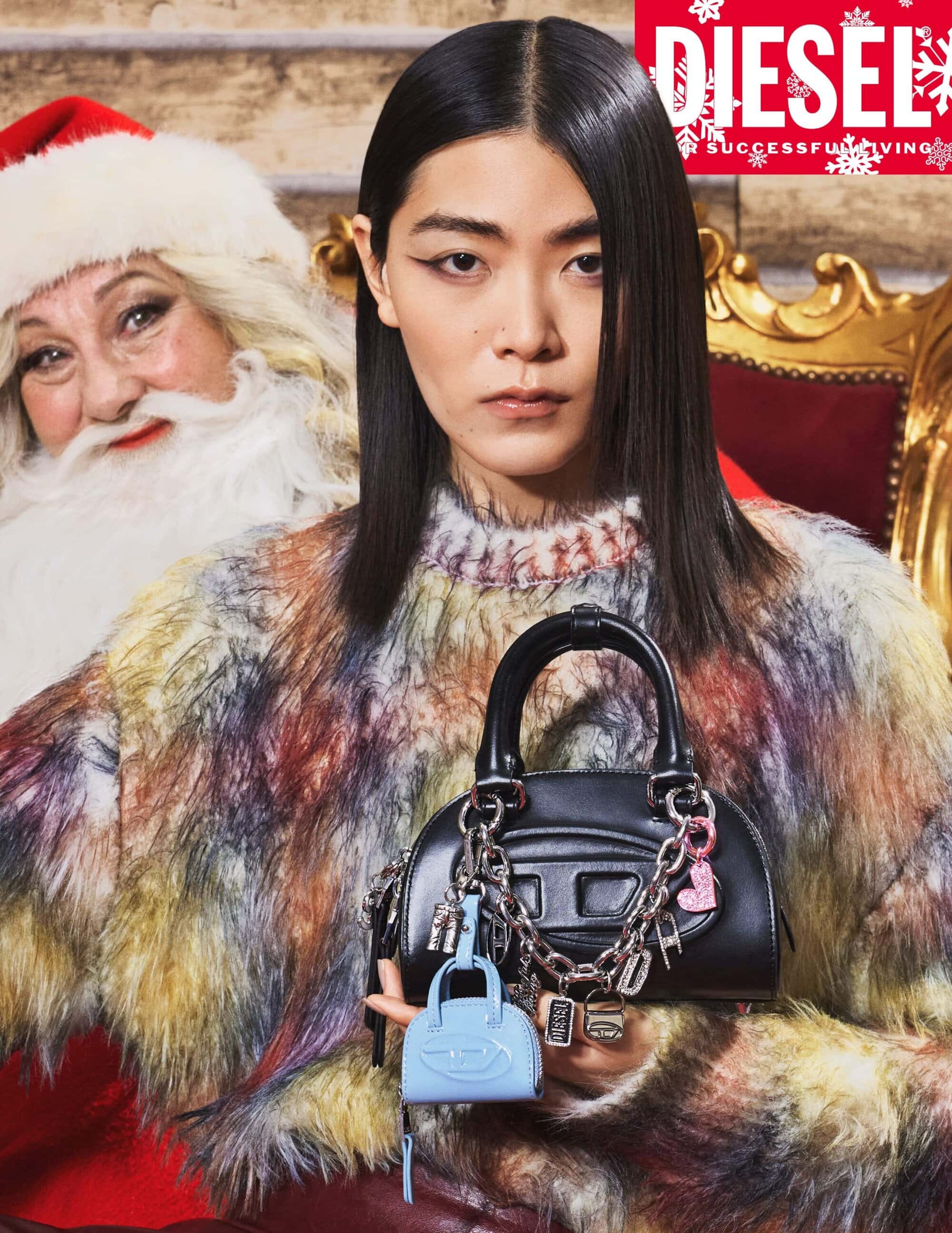 Asian woman poses with a Diesel handbag and Santa Claus in a holiday-themed fashion shot for an advertisement; seasonal campaign.