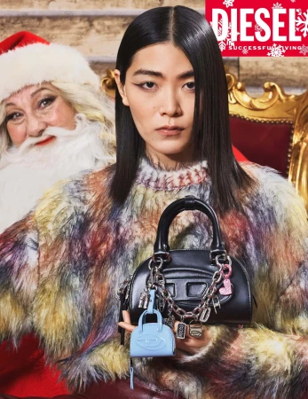 Asian woman poses with a Diesel handbag and Santa Claus in a holiday-themed fashion shot for an advertisement; seasonal campaign.
