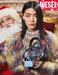 Asian woman holding a black leather handbag with silver charms next to a person dressed as Santa Claus.