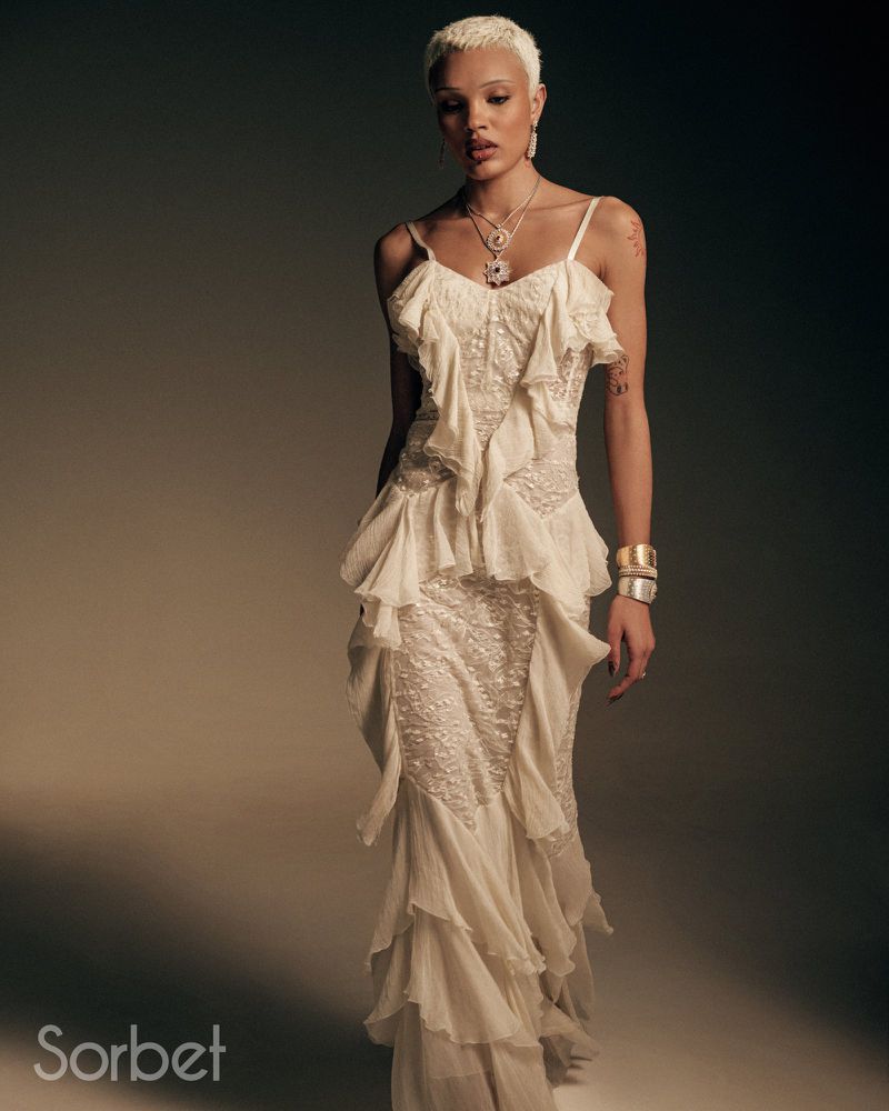 Elegant woman in ruffle dress. Close-up shot captures the beauty of her attire and the soft studio lighting enhancing the fashion.