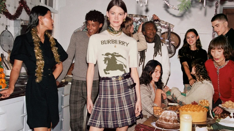 Group of models celebrate holiday season with food, wearing fashion clothing in an indoor environment with various colors and decorations.