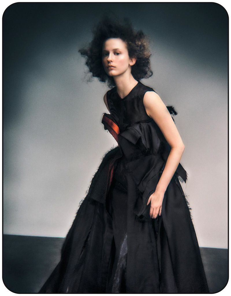 Model Melinda Kiss in a black sculptural dress with voluminous silhouette for Harper's Bazaar Germany editorial by Dima Hohlov