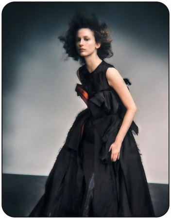 Model Melinda Kiss in a black sculptural dress with voluminous silhouette for Harper's Bazaar Germany editorial by Dima Hohlov