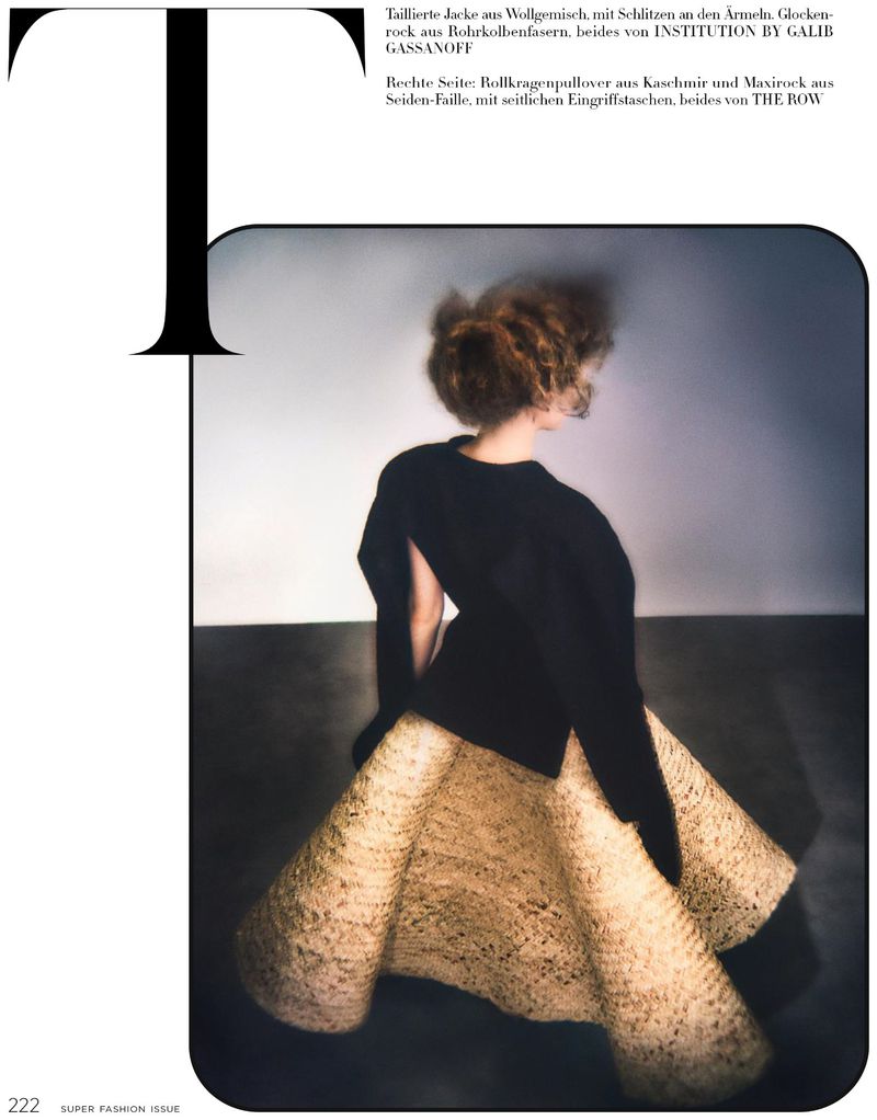 Fashion shot featuring an adult female model with curled hair in a black jacket and beige textured maxi skirt against a gradient gray backdrop.
