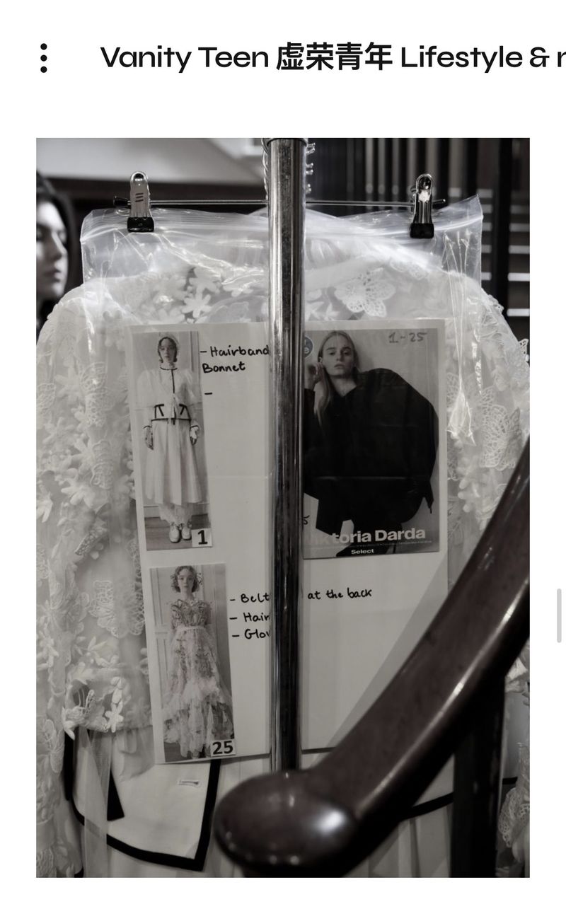 Behind the scenes glimpse of high fashion: garments on a rack, design sketches, monochromatic aesthetic. Ideal for fashion creatives.