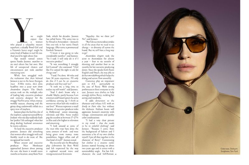 Headshot of Famke Janssen wearing sunglasses and a beige coat against a diffused purple background in a stylish editorial layout.