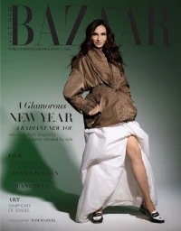 Famke Janssen on Harper's Bazaar Vietnam magazine cover wearing a brown puffer jacket and white skirt