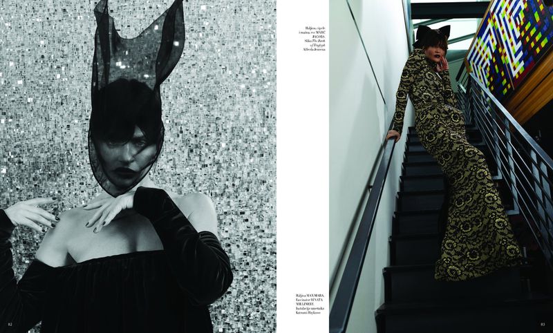 Two fashion models pose in a black-and-silver monochromatic aesthetic, one in a veiled headdress, the other on stairs in a patterned gown.