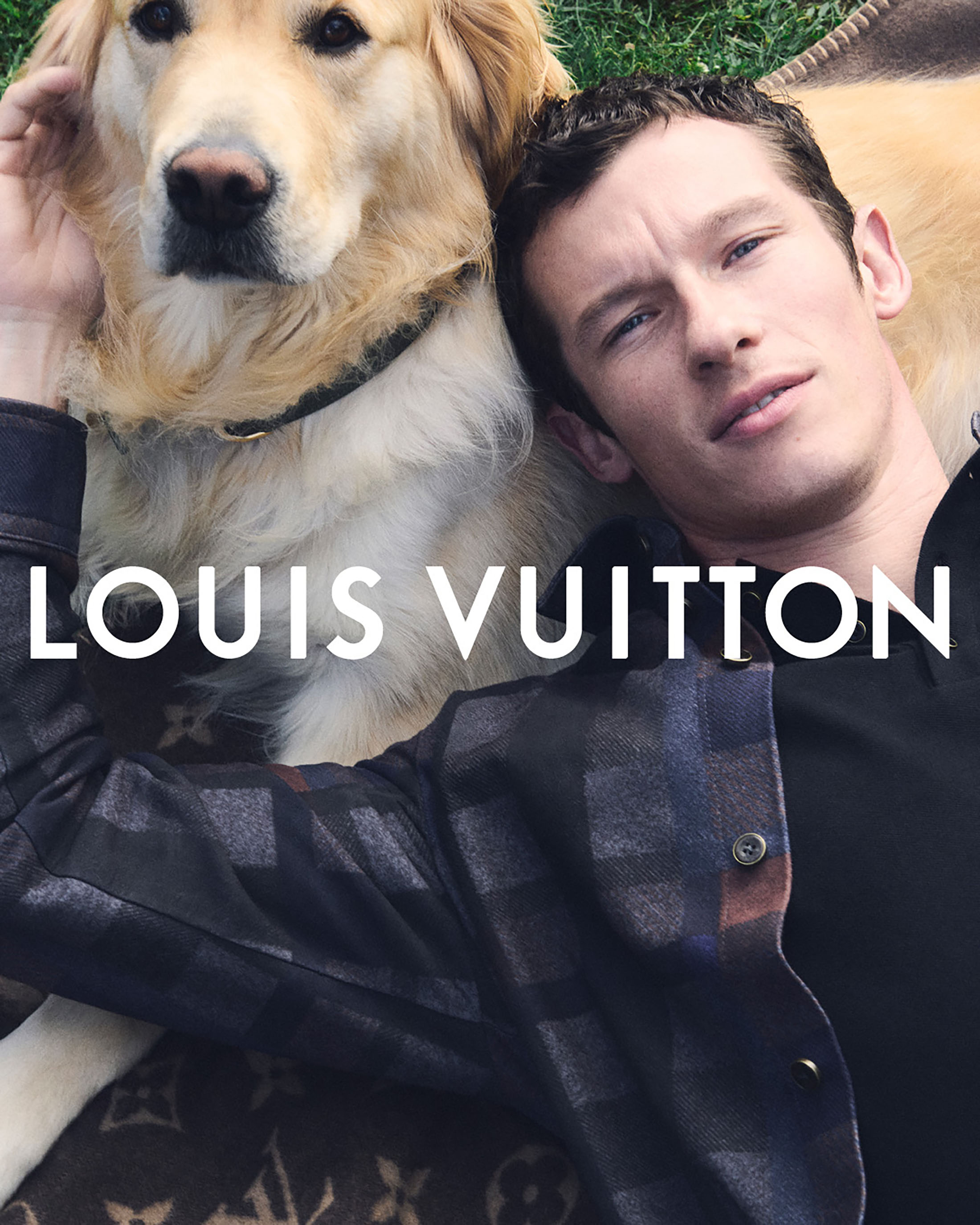 Adult male and golden retriever dog posing in an outdoor shot, lying on a patterned blanket with a prominent Louis Vuitton logo.