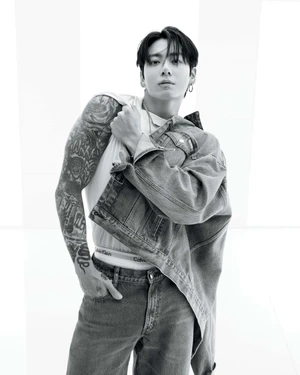 Jung Kook in a black and white fashion portrait wearing a denim jacket and white tank top for Calvin Klein
