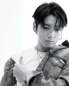 Jung Kook wearing a white t-shirt and denim jacket in a black and white portrait for Calvin Klein