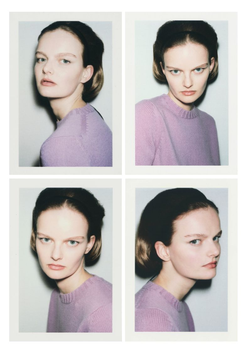 Polaroid of a fair-skinned young woman with short brown hair wearing a lavender sweater, shot multiple times against a grey wall.
