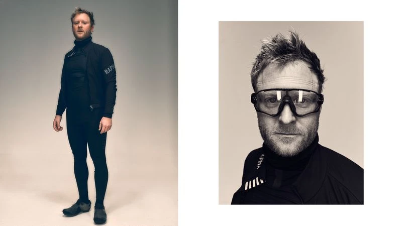Man in athletic wear stands in a studio with black and white close up in sepia tones. He wears goggles and a black turtleneck.