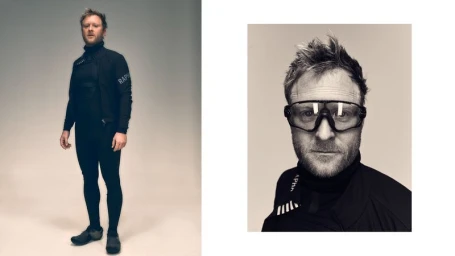 Man wearing cycling apparel and performance sunglasses in a studio setting for a Rapha project