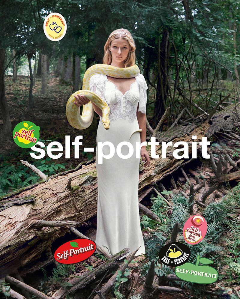 A young woman in a white dress holds a python in a forest with brand logos overlaid, creating a surreal, branded fashion image.