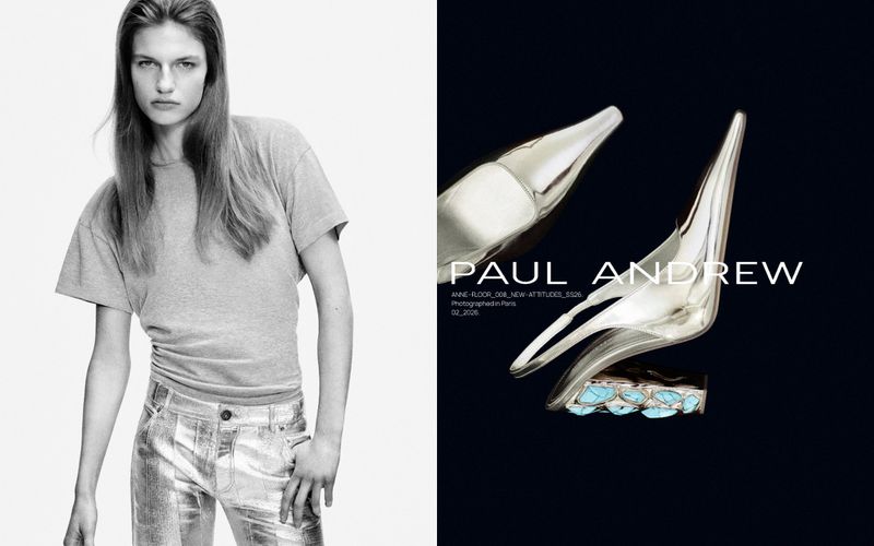 Black and white fashion shot featuring a woman in a t-shirt and metallic pants beside a silver shoe on a dark background.