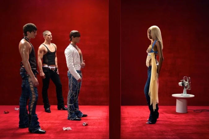 Three men in trendy outfits standing near a blonde woman against a red backdrop with a retro fan, capturing a unique fashion moment.