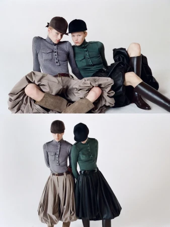 Two fashion models pose in a studio wearing riding caps, form-fitting tops, and distinctive skirts, exhibiting a high-fashion equestrian style.