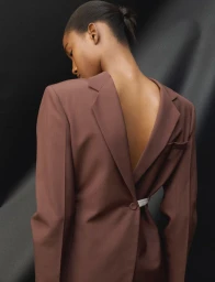 Model wearing a reverse brown blazer with a white belt for Muse Magazine photographed by Maona Micoud