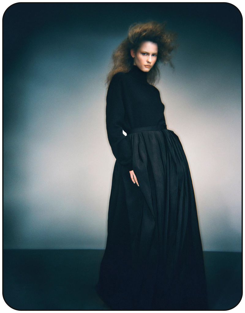 Model Melinda Kiss in a black turtleneck and voluminous skirt against a gradient background for Harper's Bazaar Germany