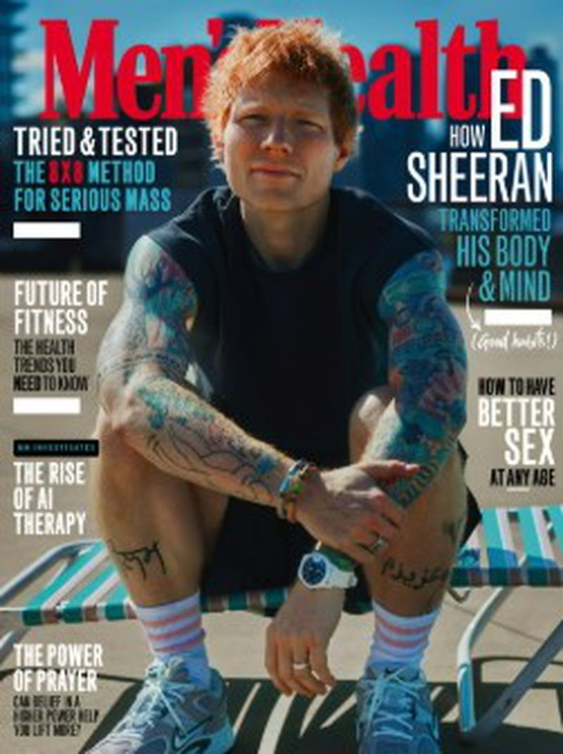 Men's Health magazine cover featuring Ed Sheeran sitting on a metal structure, wearing a black t-shirt, shorts, sneakers and socks.