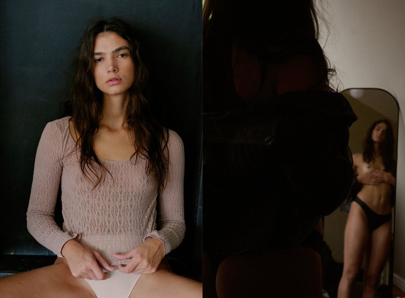 Woman in a lace bodysuit sits in front of a dark wall, with a second image showing her reflection in a mirror.