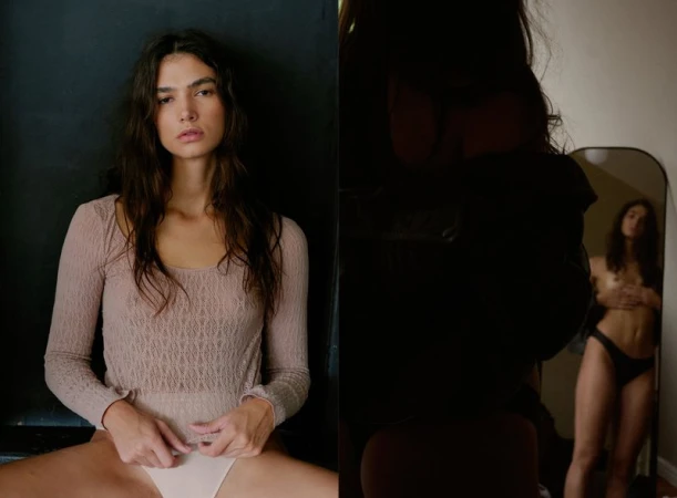 Woman in a lace bodysuit sits in front of a dark wall, with a second image showing her reflection in a mirror.