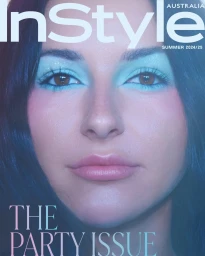 Close-up portrait of a woman with vibrant light blue eyeshadow and long dark hair for InStyle Australia magazine cover
