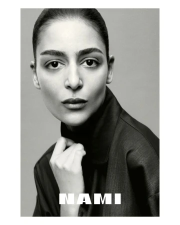 Monochrome portrait of a woman with a neutral expression, wearing a dark collared shirt against a plain background, featuring the text 'NAMI'.
