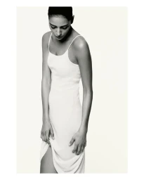 Model Nora Attal wearing a white slip dress against a clean background for Nami photographed by Robin Galiegue.