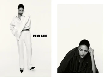 Model Nora Attal in a white shirt and trousers standing next to the Nami logo, photographed by Robin Galiegue against a white background.