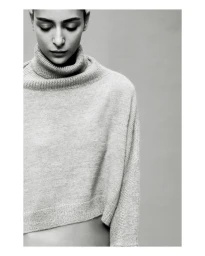 Model Nora Attal wearing a textured grey turtleneck sweater in a studio portrait for Nami Drop 4.