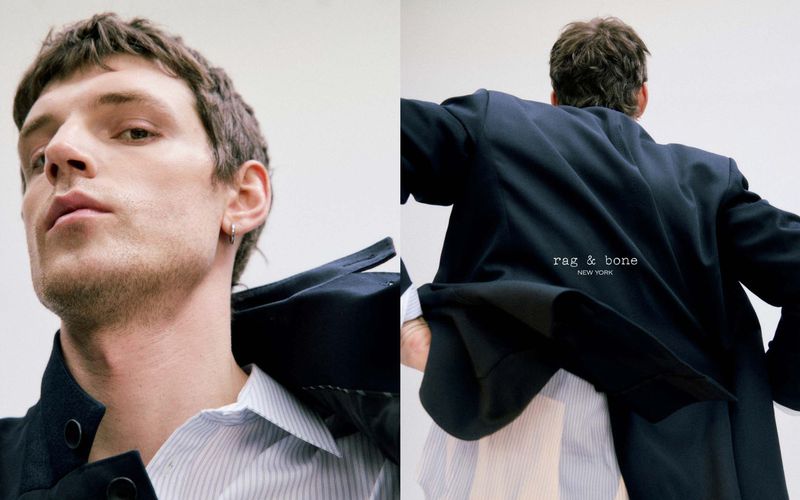 Portrait of a fashionable adult male wearing a blazer and collared shirt against a bright white backdrop in a studio setting.