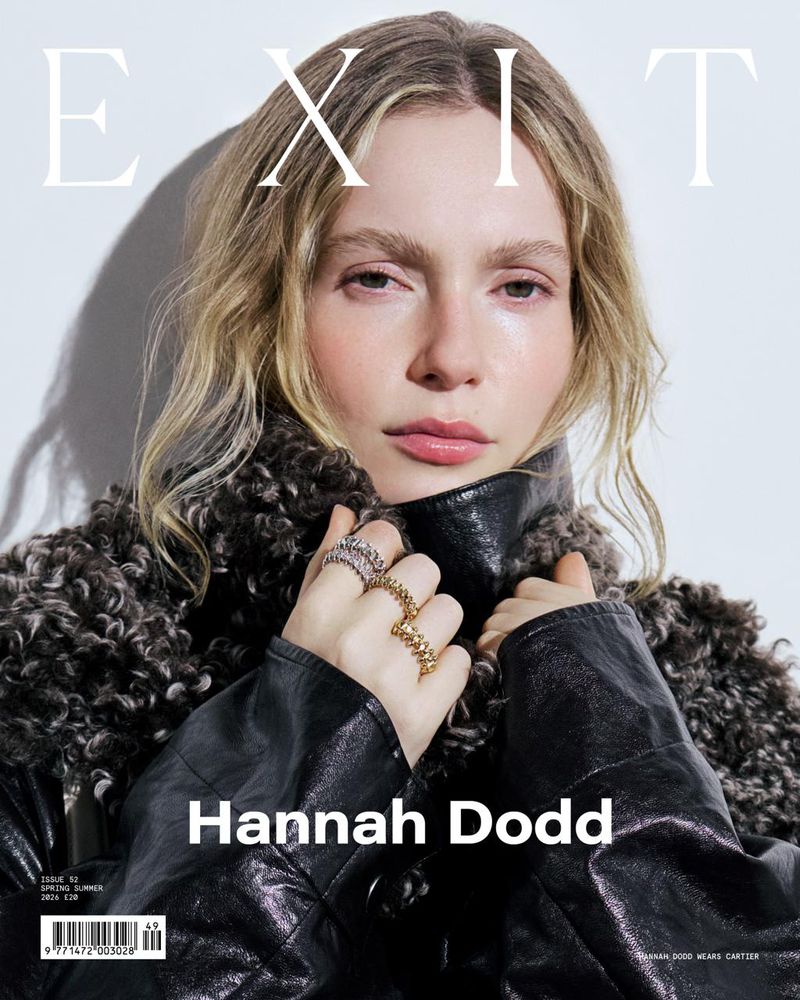 Magazine cover portrait of Hannah Dodd with light blonde hair, wearing a black leather jacket and silver and gold rings against white.