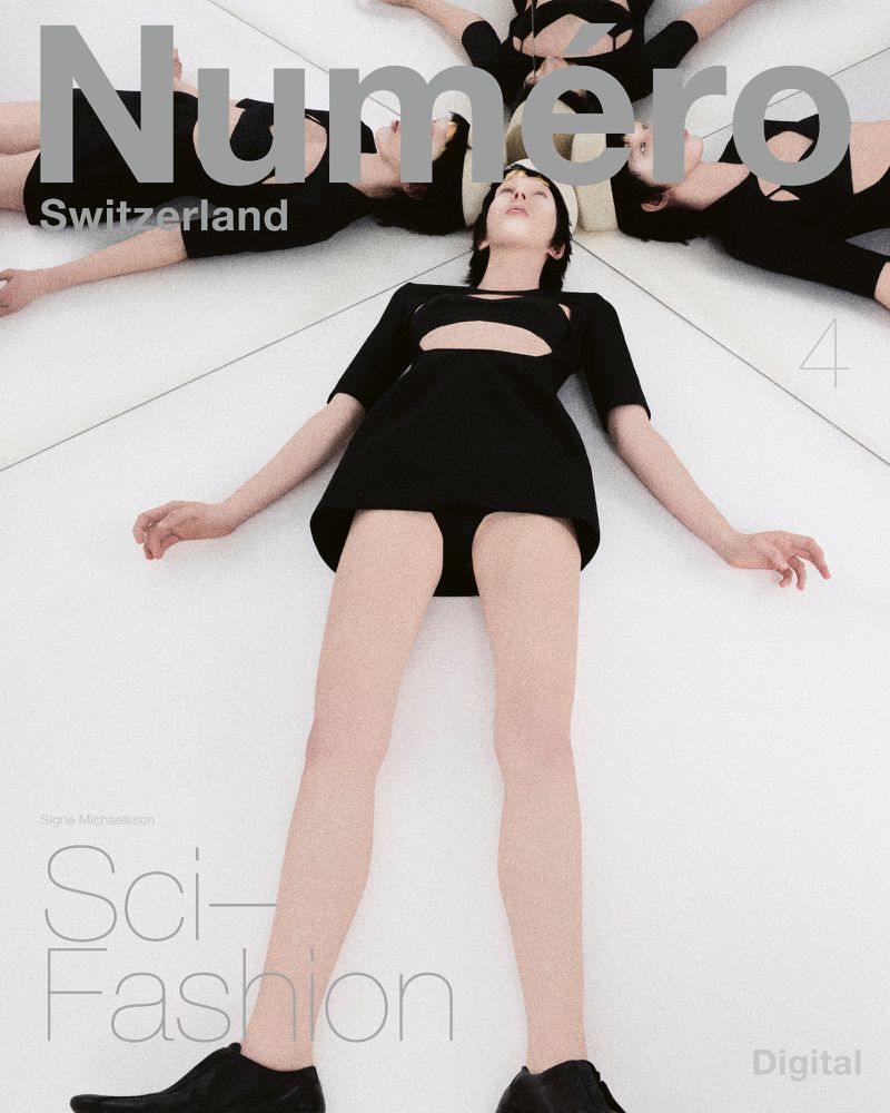 Fashion magazine cover featuring a woman lying on a white surface, surrounded by mirrored reflections of other women in black outfits.
