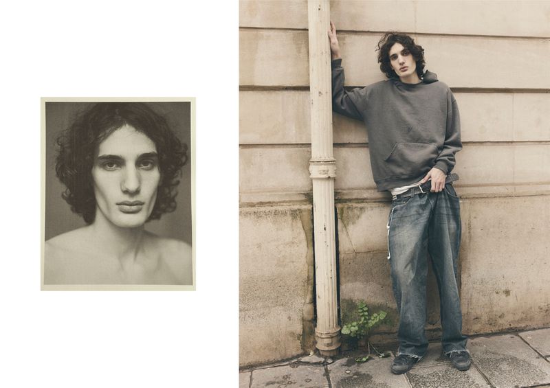 Male fashion model in gray hoodie and baggy jeans poses outside next to a B&W portrait in a muted neutral color palette.