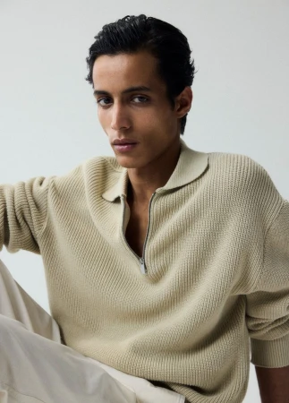 Model wearing a textured cream knit polo sweater against a neutral background for U Repubblica