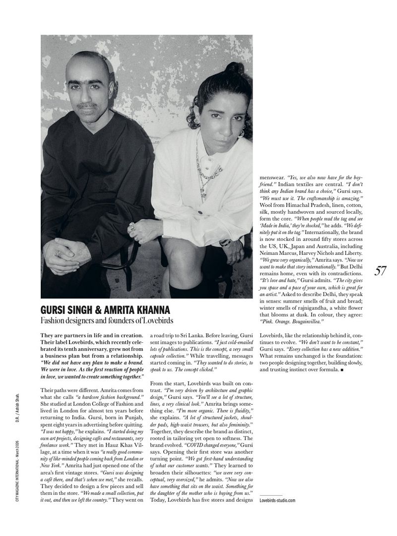 A black and white portrait of fashion designers Gursi Singh and Amrita Khanna sitting side-by-side, looking at the camera.