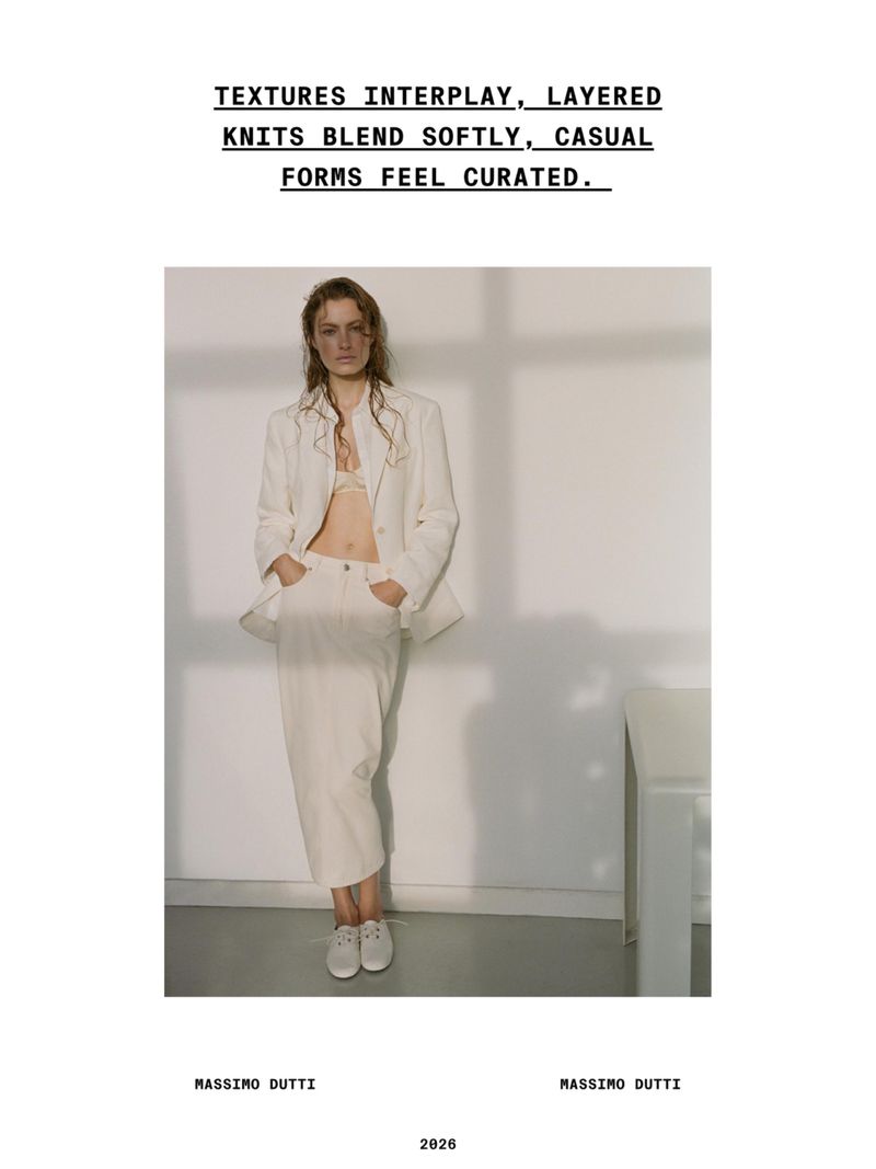 Felice Nova Noordhoff in an off-white blazer and skirt standing before a wall with soft window shadow casting.