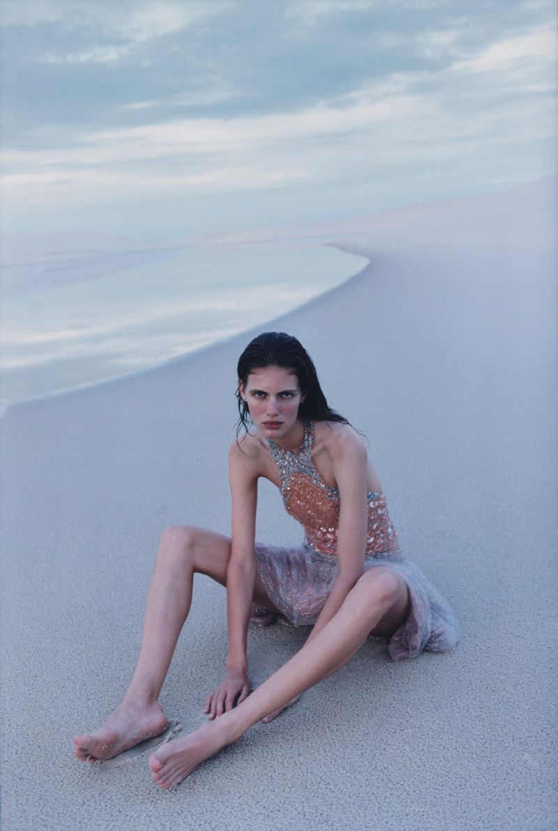 Model Rosalieke Fuchs sitting barefoot on sand dunes under an overcast sky for Harper's Bazaar U.S. Oasis Effect editorial