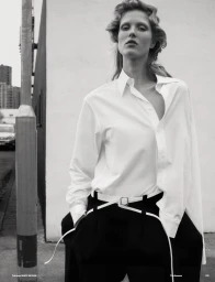 Model Vakare Steputyte wearing a white button-down shirt and black trousers outdoors for Muse Magazine