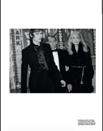 Black and white editorial fashion image featuring Diana Skowron in a black suit with three figures in a theatre or street setting.